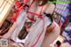 A woman in a red and white lingerie is posing for the camera.