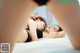 A couple of women laying on top of a bed.