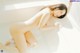 A naked woman sitting in a bathtub with water.